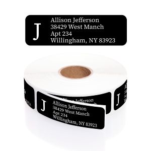 A roll of rectangular black return address labels featuring a large monogram letter J and clean white block text for the address.