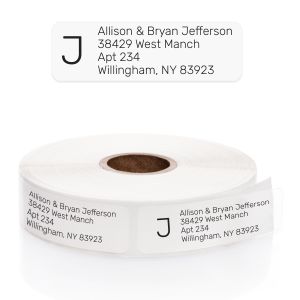 A paper roll of clear address labels featuring a bold black letter J initial monogram layout template on a clean white background.