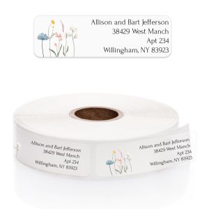 A close-up view of a roll of clear address labels showcasing the repeating wildflower design and customizable centered text templates.