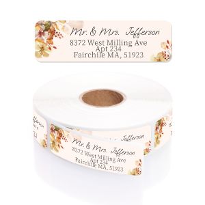 A personalized return address label with a rustic burnt orange floral border, shown above its matching rolled label and clear dispenser.