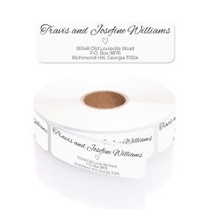 A personalized return address label with an elegant, minimalist line-art heart and script font, shown above its matching roll and clear dispenser.