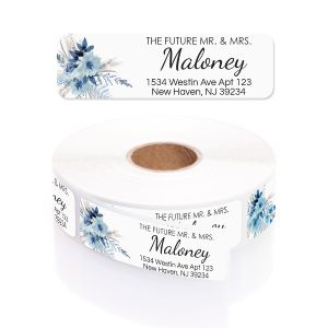 Blue floral address label displayed above a roll of custom return address stickers featuring elegant calligraphy font and floral accents.