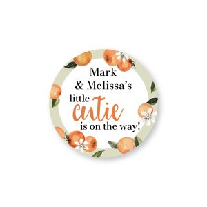 Round personalized baby shower label with orange clementine illustrations and text reading 