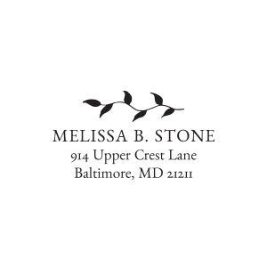A crisp black impression of a custom address stamp, featuring a delicate trailing leaf vine illustration above a personalized name and address.