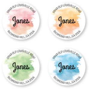 Four circular personalized address labels showcasing vibrant watercolor paint splatters in pink, orange, green, and blue with custom text.