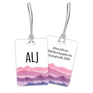 Personalized Watercolor Mountains luggage tag displaying pink and purple mountain art, monogram front, and custom address back.