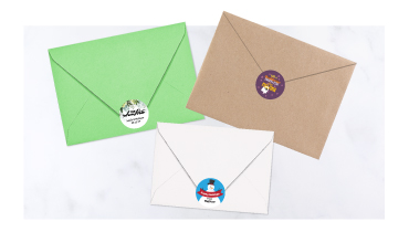 Custom round envelope seals with festive holiday themes, wedding details, and everyday designs.