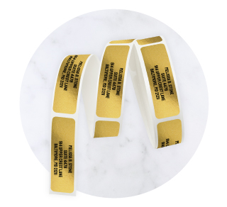 Metallic gold and silver foil address labels by Current Labels with a reflective finish.